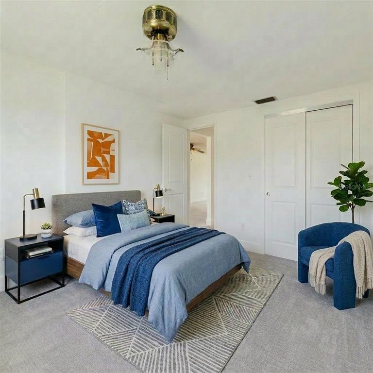 4235 Stratford Drive New Port Richey, FL 34652 - Photo 23 of 36 a bedroom with a bed and a potted plant