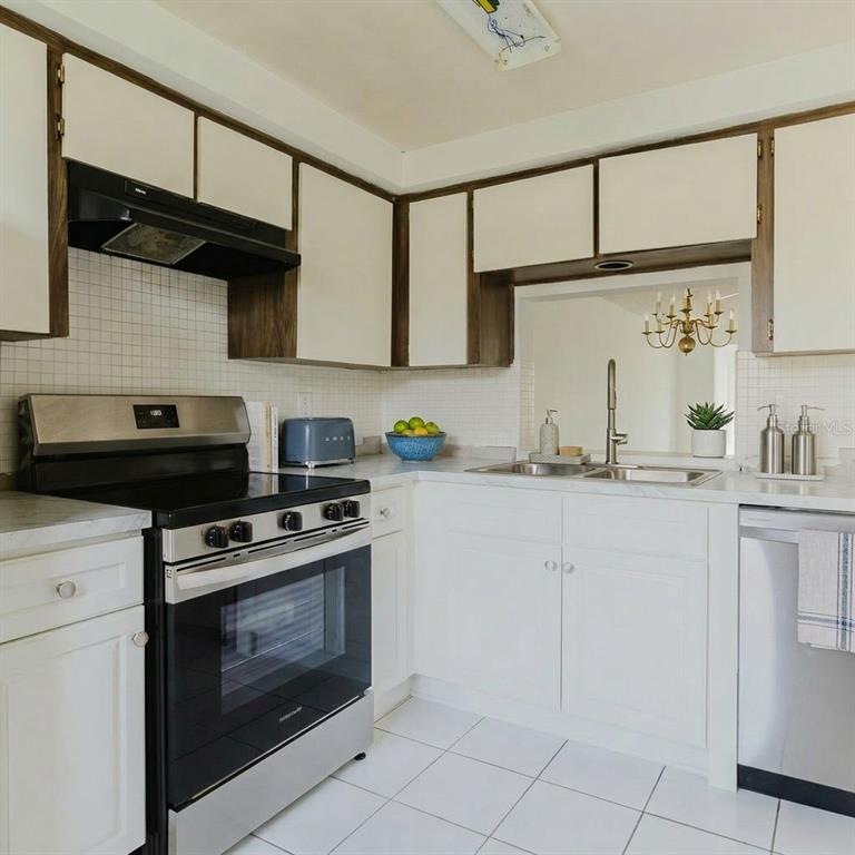4235 Stratford Drive New Port Richey, FL 34652 - Photo 5 of 36 a kitchen with granite countertop cabinets stainless steel appliances and a sink