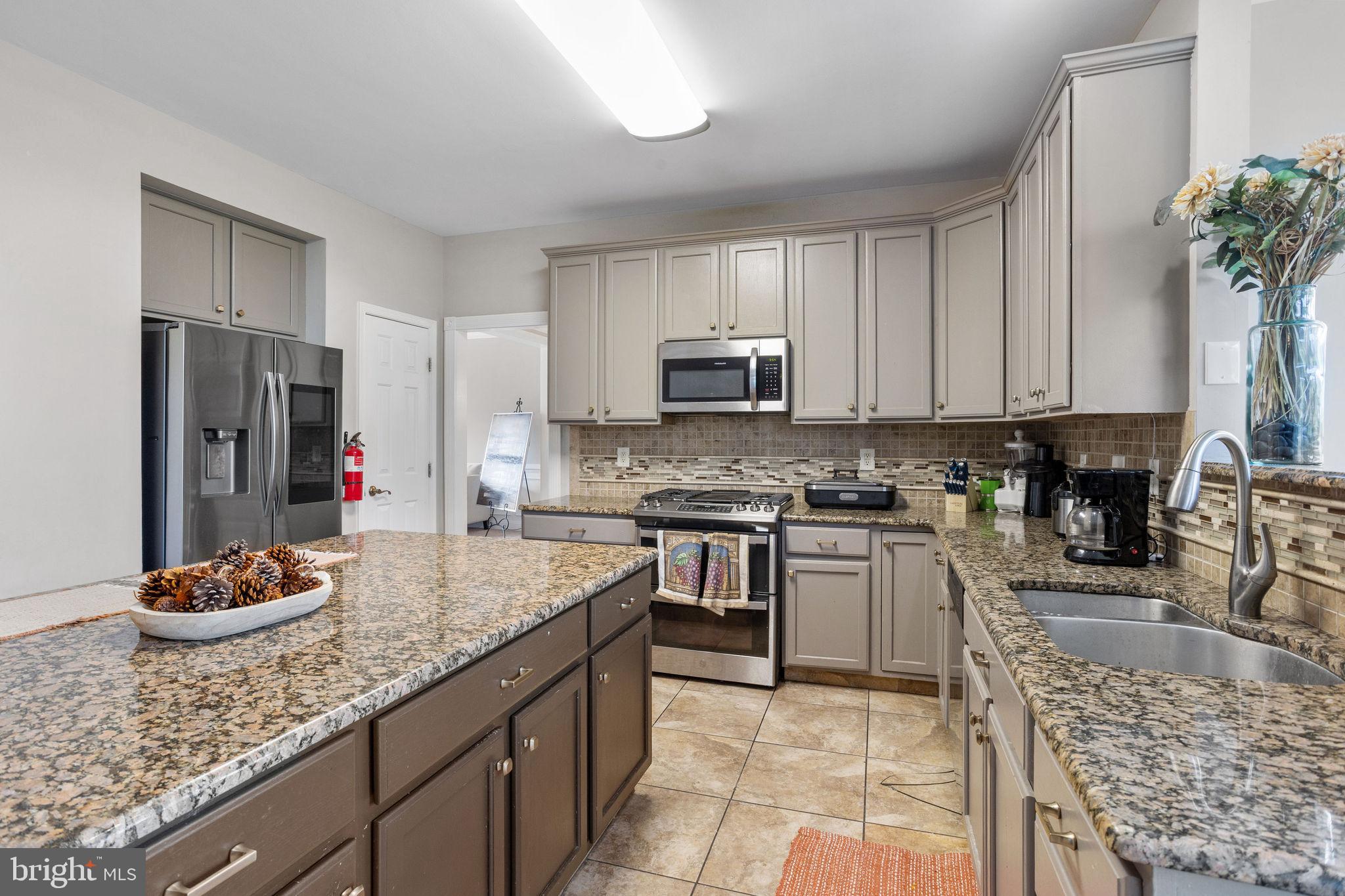 44 Red Fox Trail Sicklerville, NJ 08081 - Photo 19 of 49 a kitchen with stainless steel appliances granite countertop a sink dishwasher stove top oven and refrigerator