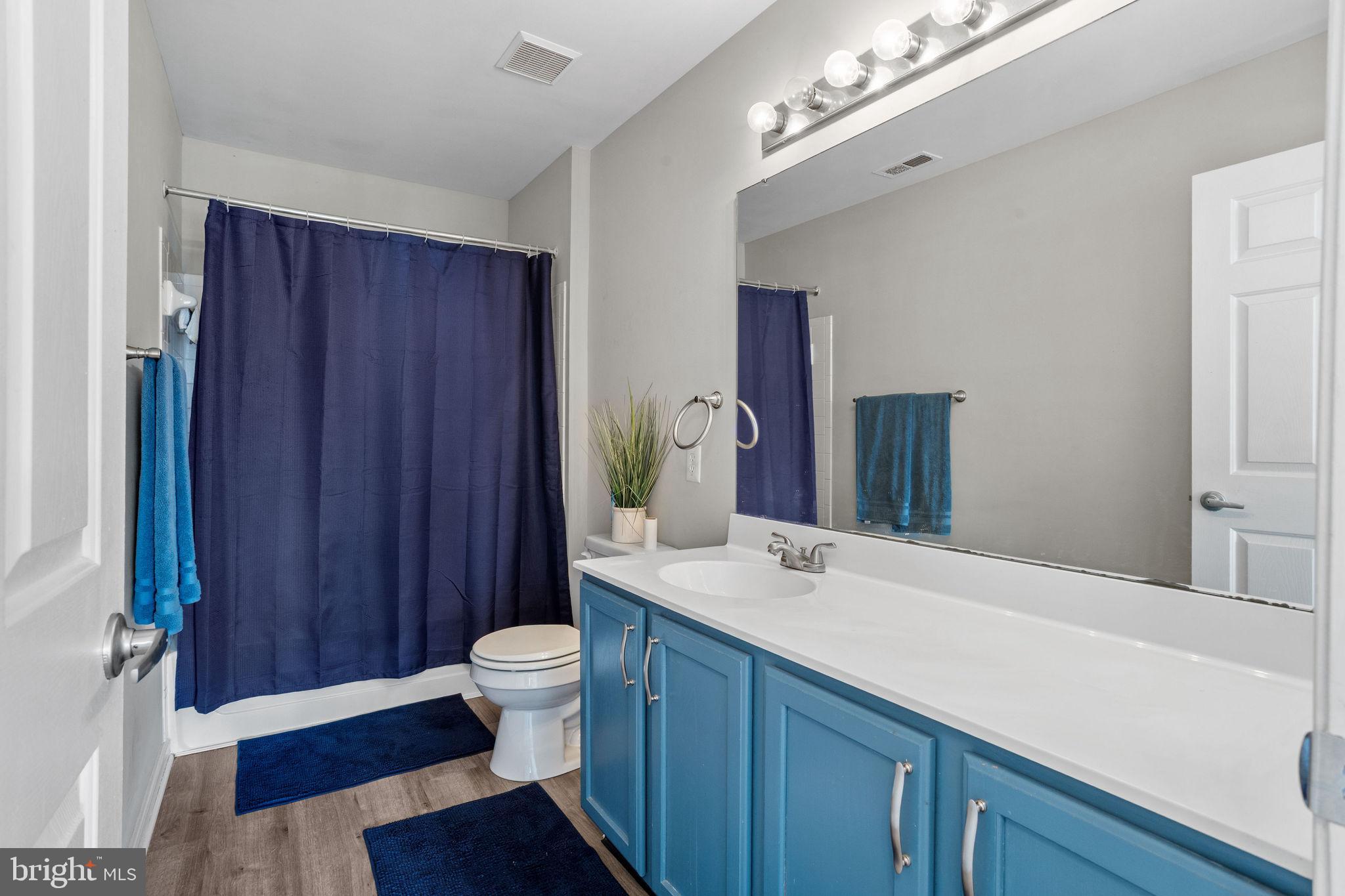 44 Red Fox Trail Sicklerville, NJ 08081 - Photo 32 of 49 a bathroom with a sink a toilet a large mirror and shower curtain