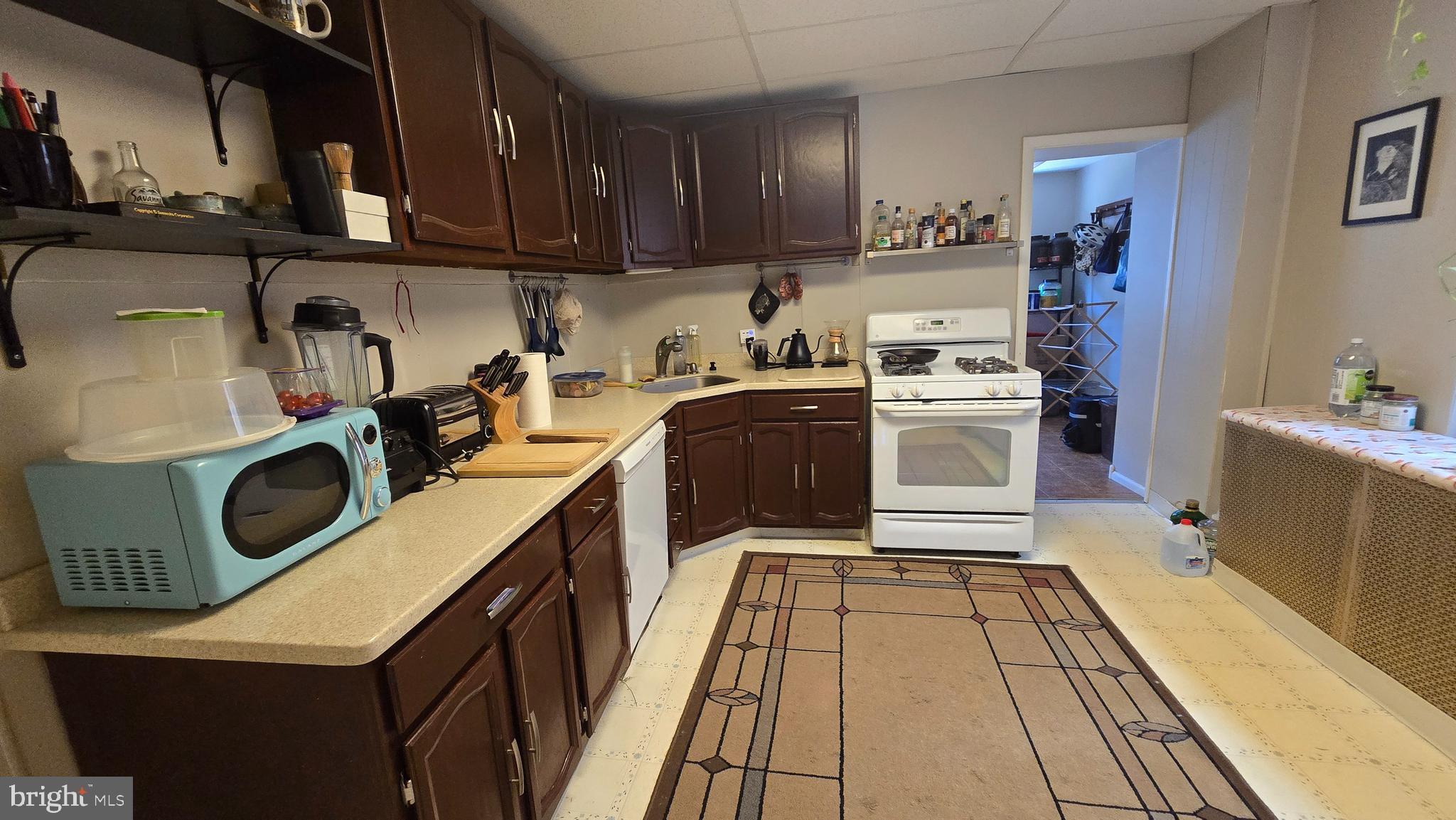 4606 Smick Street Philadelphia, PA 19127 - Photo 7 of 21 a kitchen with a sink a stove top oven and cabinetry
