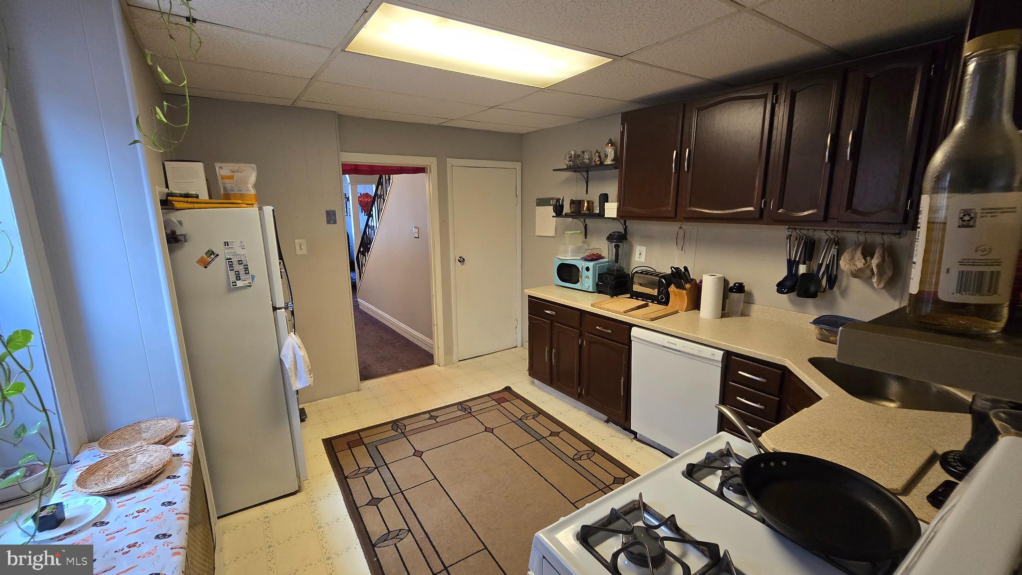 4606 Smick Street Philadelphia, PA 19127 - Photo 8 of 21 a kitchen with stainless steel appliances granite countertop a refrigerator a sink dishwasher and wooden cabinets