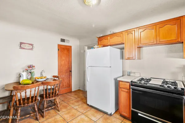 a dining room with furniture a refrigerator and a table