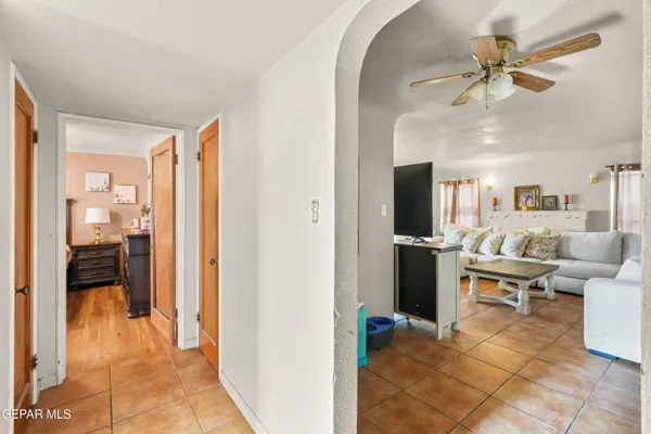 a living room with furniture and a view of bedroom