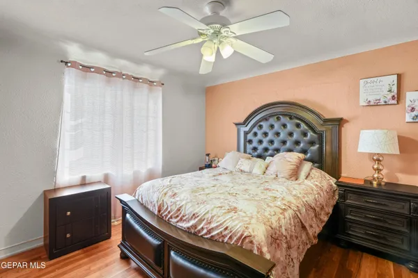 a bedroom with a bed and a chandelier