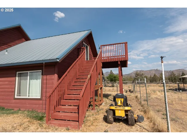 a view of balcony with wooden floor and fence