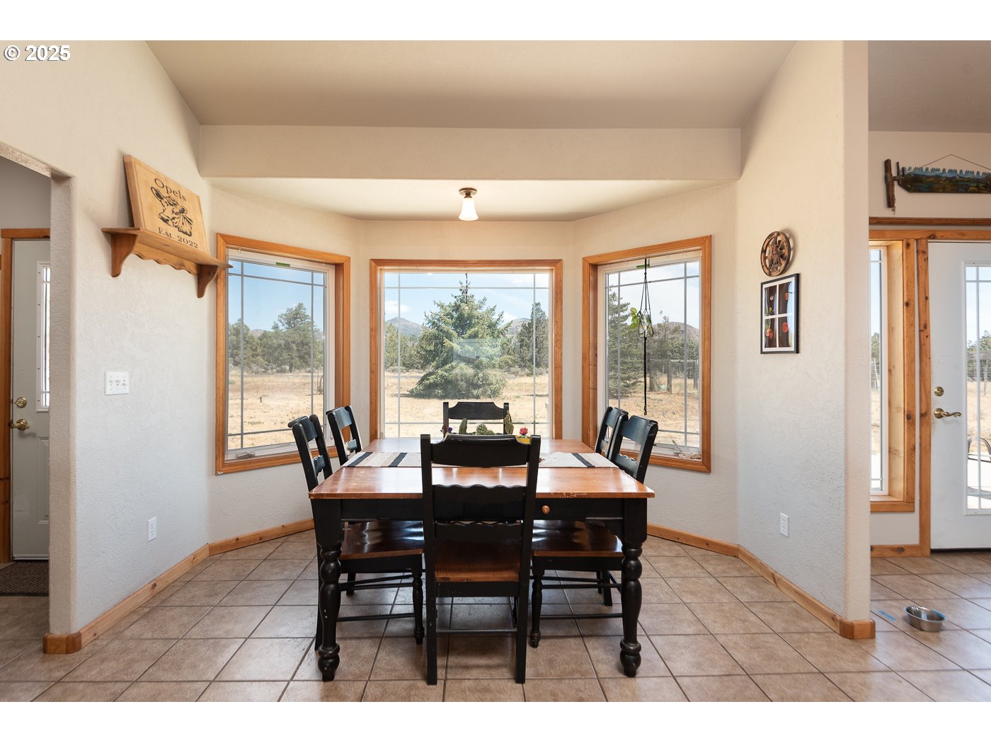 15990 Southwest Culver Highway Culver, OR 97734 - Photo 4 of 41 a view of a dining room with furniture large windows and wooden floor