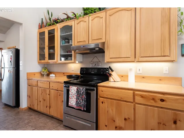 a kitchen with stainless steel appliances granite countertop a stove a sink and dishwasher
