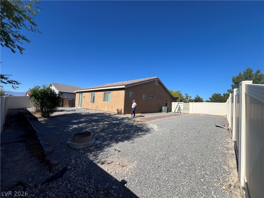 6472 Centennial Road Pahrump, NV 89048 - Photo 32 of 33 A low-maintenance yard offers ample outdoor living space, enclosed by robust fencing.