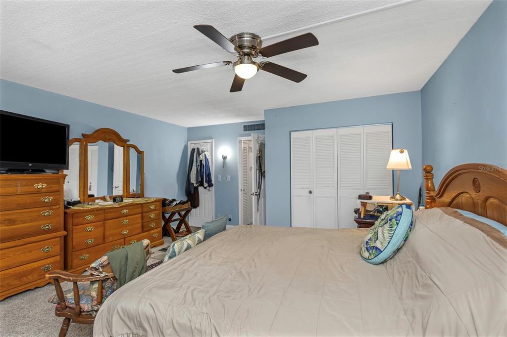 4742 Azalea Drive, Unit 106 New Port Richey, FL 34652 - Photo 11 of 34 a bedroom with bed and ceiling fan