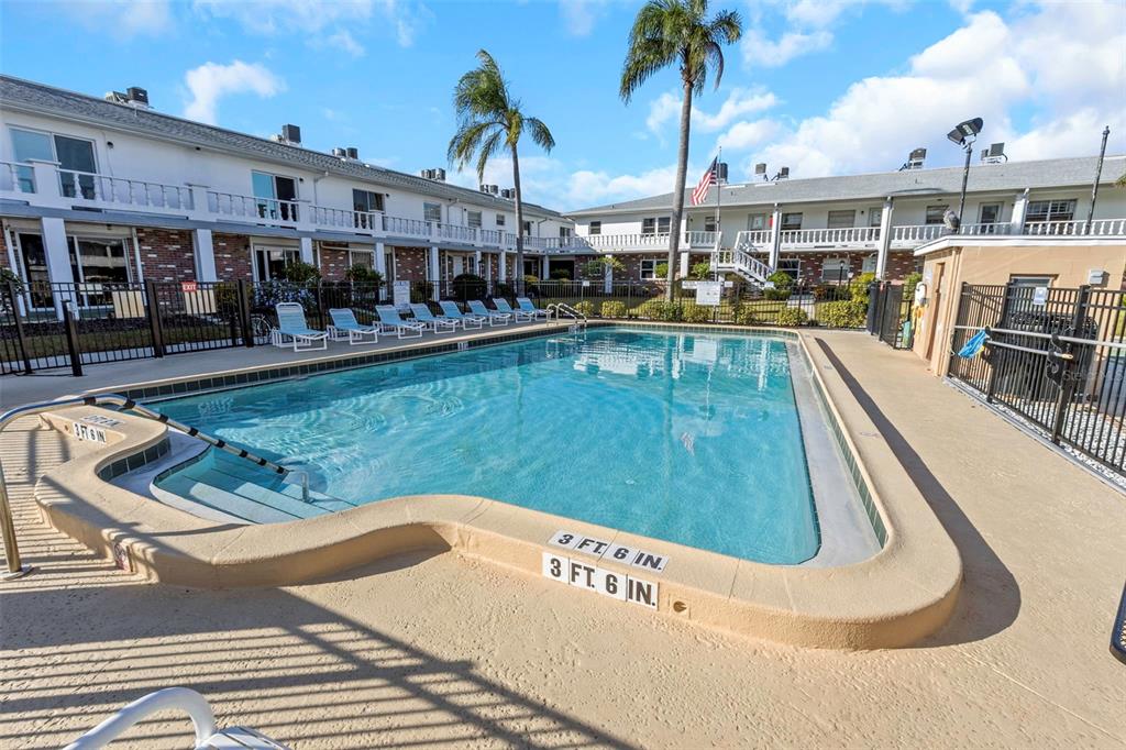 4742 Azalea Drive, Unit 106 New Port Richey, FL 34652 - Photo 21 of 34 a view of a swimming pool with a patio