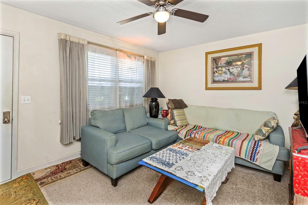 4742 Azalea Drive, Unit 106 New Port Richey, FL 34652 - Photo 8 of 34 a living room with furniture and a window