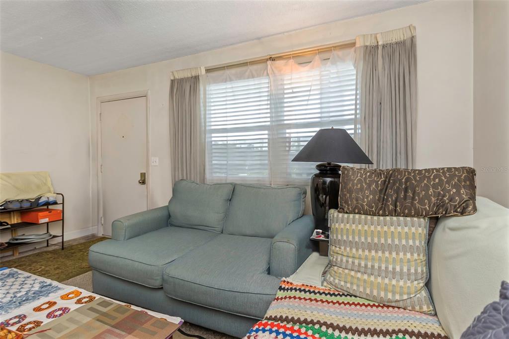 4742 Azalea Drive, Unit 106 New Port Richey, FL 34652 - Photo 9 of 34 a living room with furniture and a window