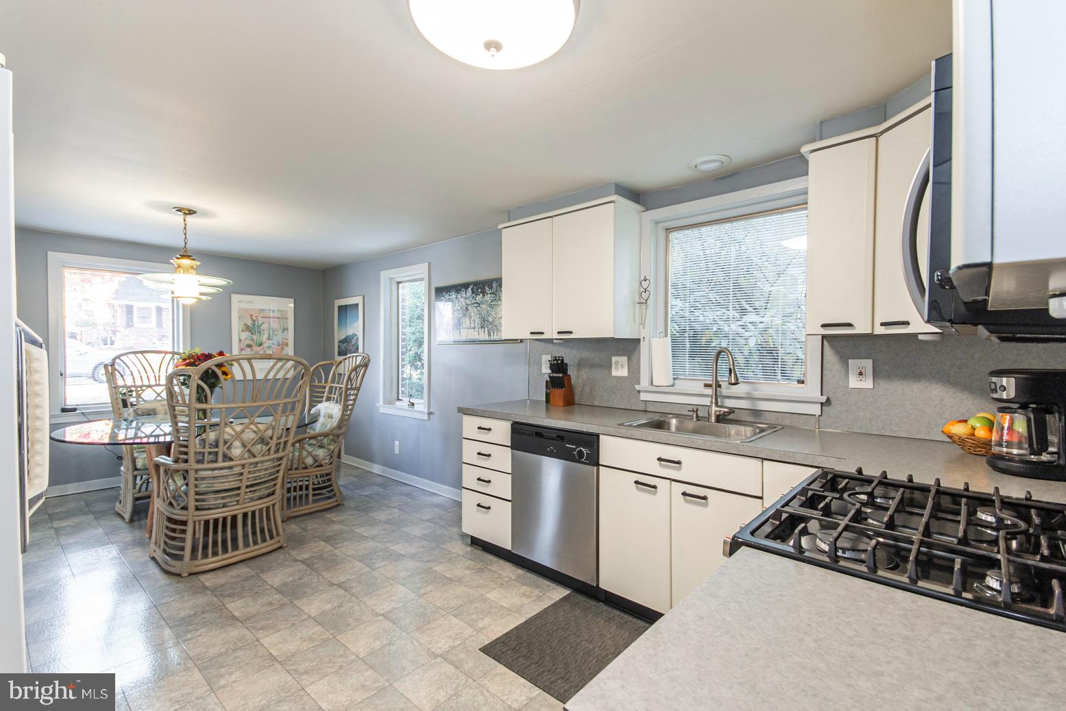 228 Valley View Road Media, PA 19063 - Photo 22 of 38 a kitchen with stainless steel appliances a table chairs sink and cabinets