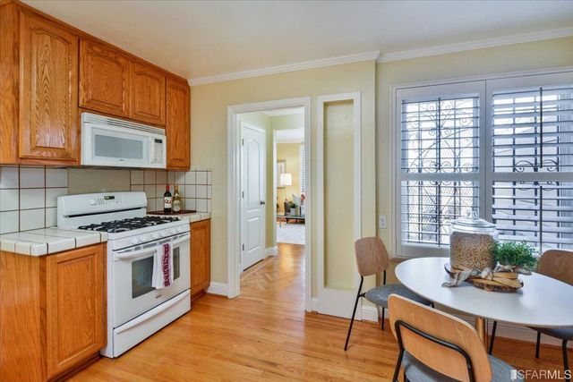 a view of a kitchen with a table and chairs