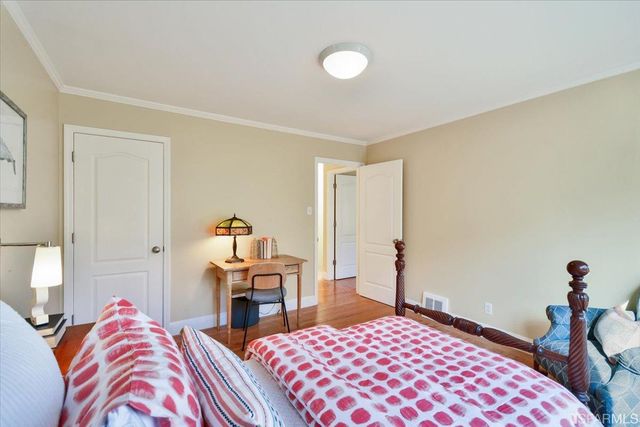 a bedroom with a bed and a lamp