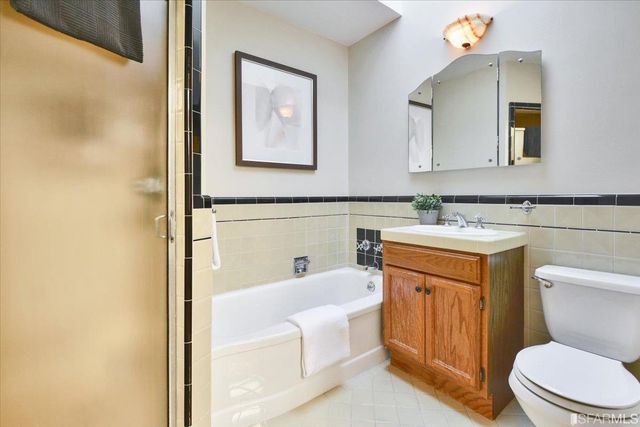 a bathroom with a toilet a sink and a mirror