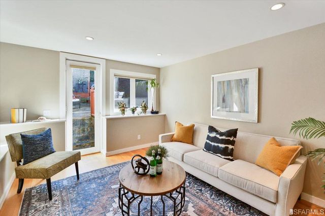 a living room with furniture and a potted plant