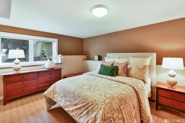 a bedroom with bed and wooden floor