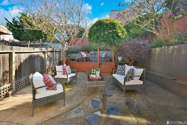 a outdoor space with the couches and a potted plant