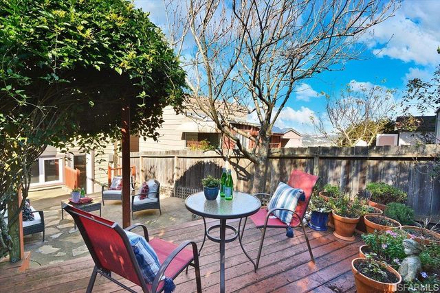a view of a chairs and table in the balcony