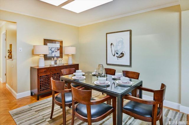 a dining room with furniture and wooden floor