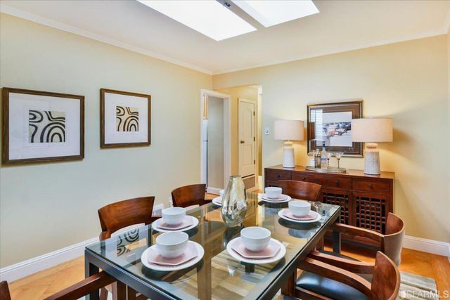 a dining room with furniture and wooden floor