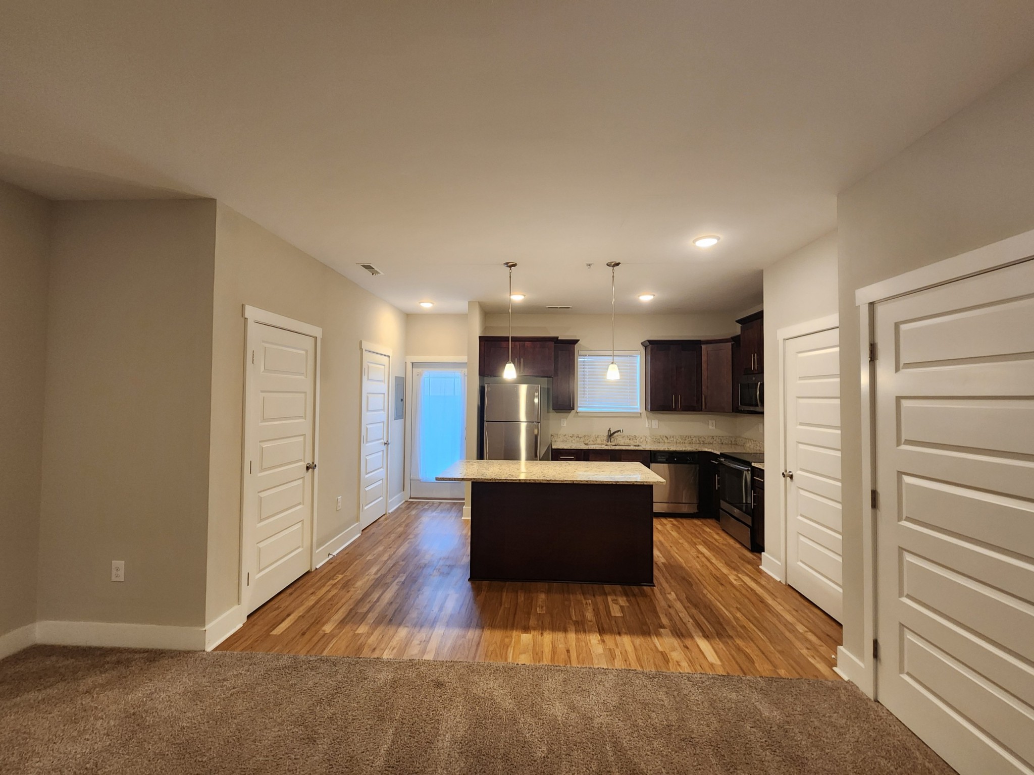 7002 Magnolia Crossings Spring Hill, TN 37174 - Photo 14 of 15 a large kitchen with kitchen island a sink stainless steel appliances and cabinets