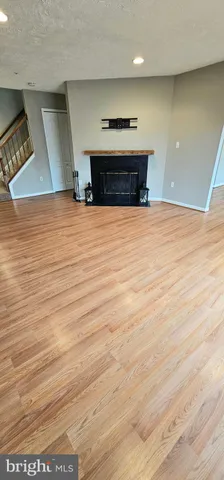 a view of kitchen with stainless steel appliances wooden floor