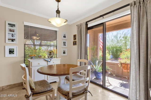 a dining room with furniture and window