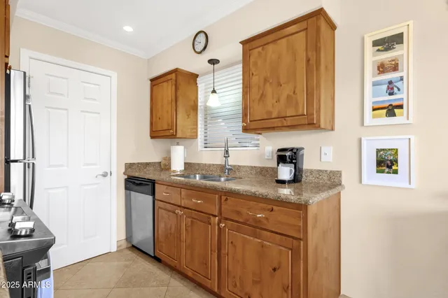 a kitchen with stainless steel appliances granite countertop a stove a refrigerator and a microwave