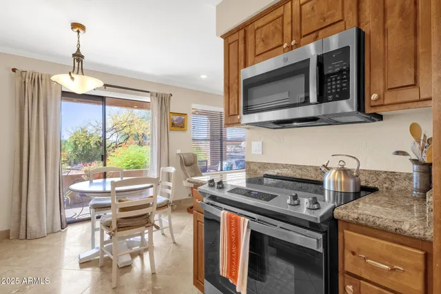 a kitchen with stainless steel appliances granite countertop a sink and cabinets