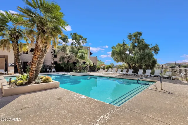 a view of swimming pool with a table and chairs