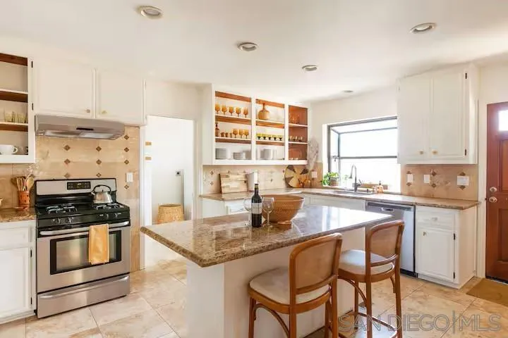 837 4th Street Encinitas, CA 92024 - Photo 14 of 41 a kitchen with stainless steel appliances granite countertop a stove a sink and a refrigerator