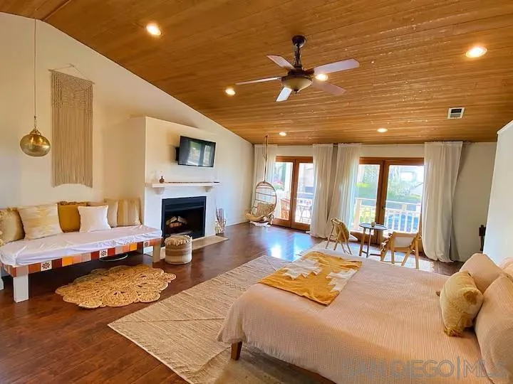 837 4th Street Encinitas, CA 92024 - Photo 17 of 41 a bedroom with furniture and a fireplace