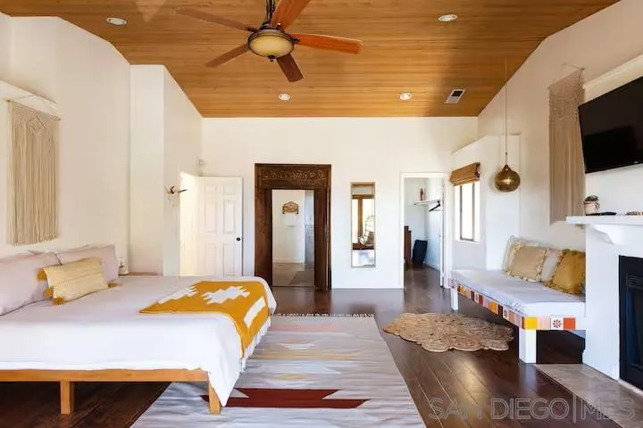 837 4th Street Encinitas, CA 92024 - Photo 17 of 41 a bedroom with a bed a flat screen tv and dresser