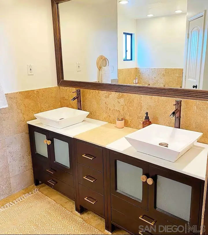 837 4th Street Encinitas, CA 92024 - Photo 22 of 41 a bathroom with a sink vanity and a mirror