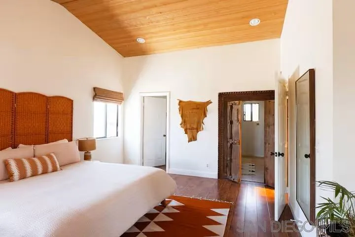 837 4th Street Encinitas, CA 92024 - Photo 25 of 41 a bedroom with a bed and a lamp on dresser