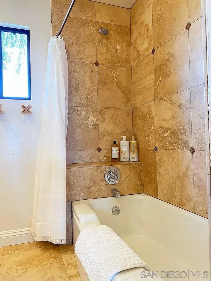 837 4th Street Encinitas, CA 92024 - Photo 29 of 41 a bathroom with a tub a sink and a shower