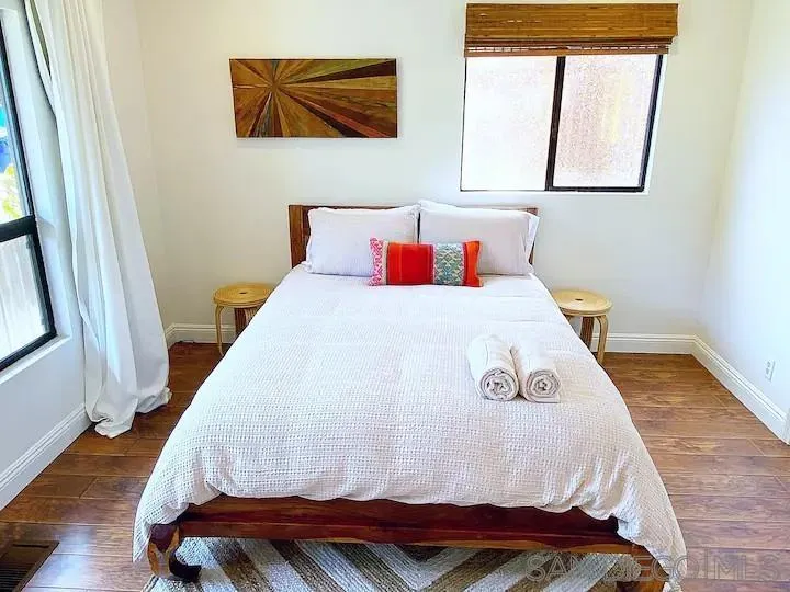837 4th Street Encinitas, CA 92024 - Photo 31 of 41 a bedroom with a bed and wooden floor