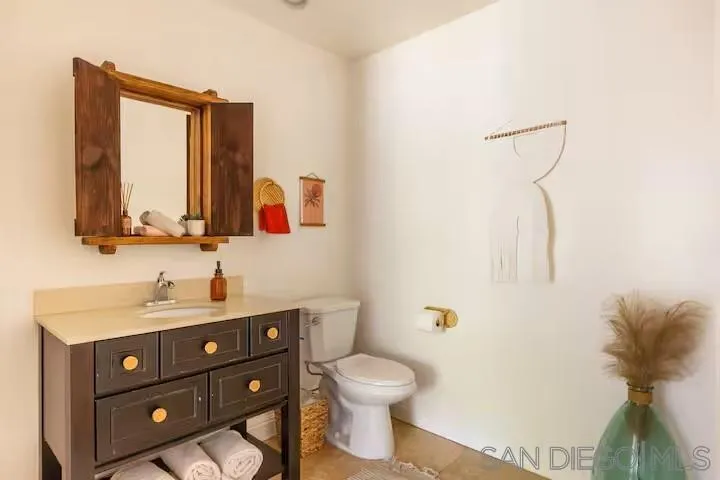 837 4th Street Encinitas, CA 92024 - Photo 34 of 41 a bathroom with a toilet sink and mirror