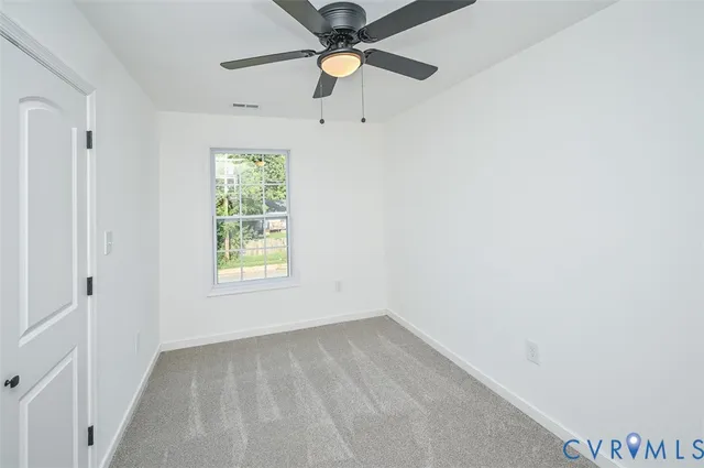 a view of a livingroom with a ceiling fan and a window