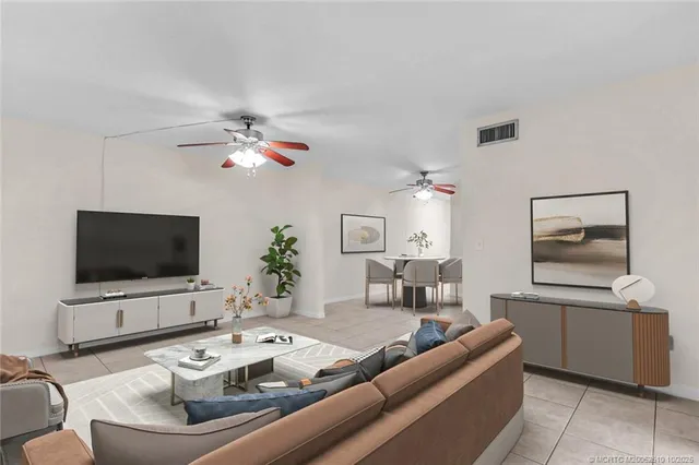 a kitchen with kitchen island granite countertop a table chairs cabinets and stainless steel appliances