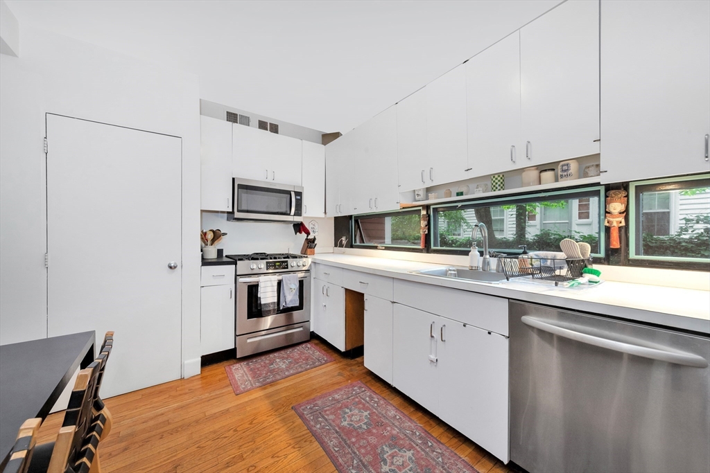 11 Maynard Place Cambridge, MA 02138 - Photo 13 of 26 a kitchen with sink cabinets and stainless steel appliances