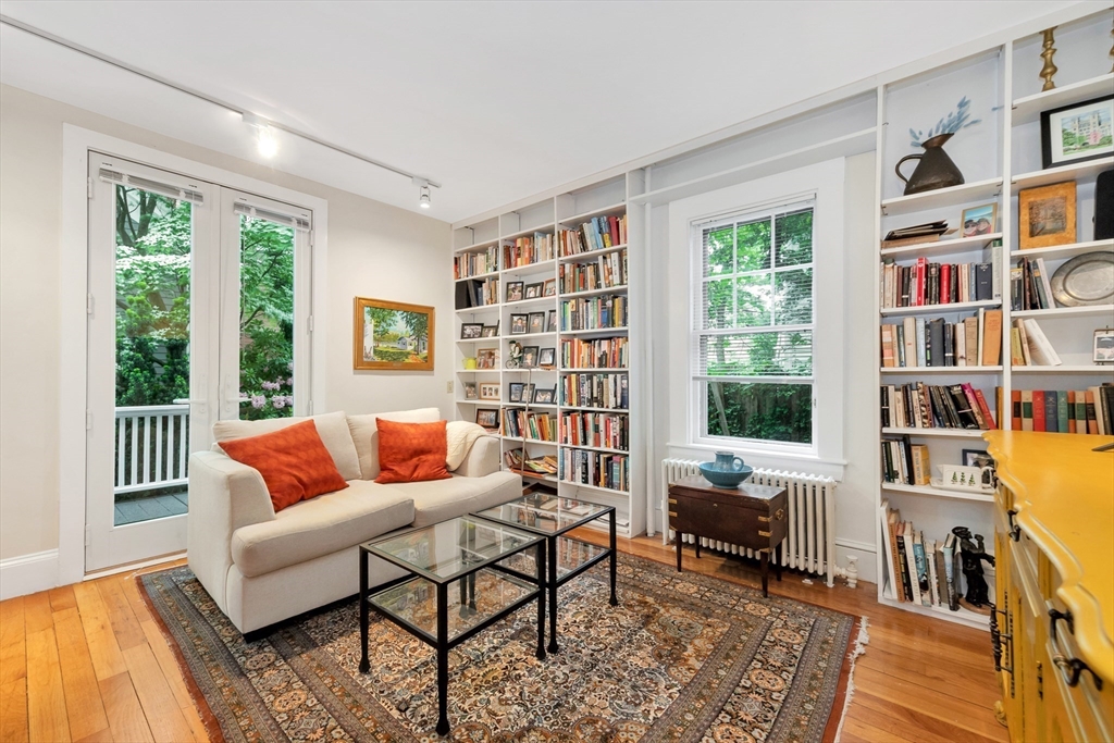 11 Maynard Place Cambridge, MA 02138 - Photo 7 of 26 a living room with furniture and a book shelf