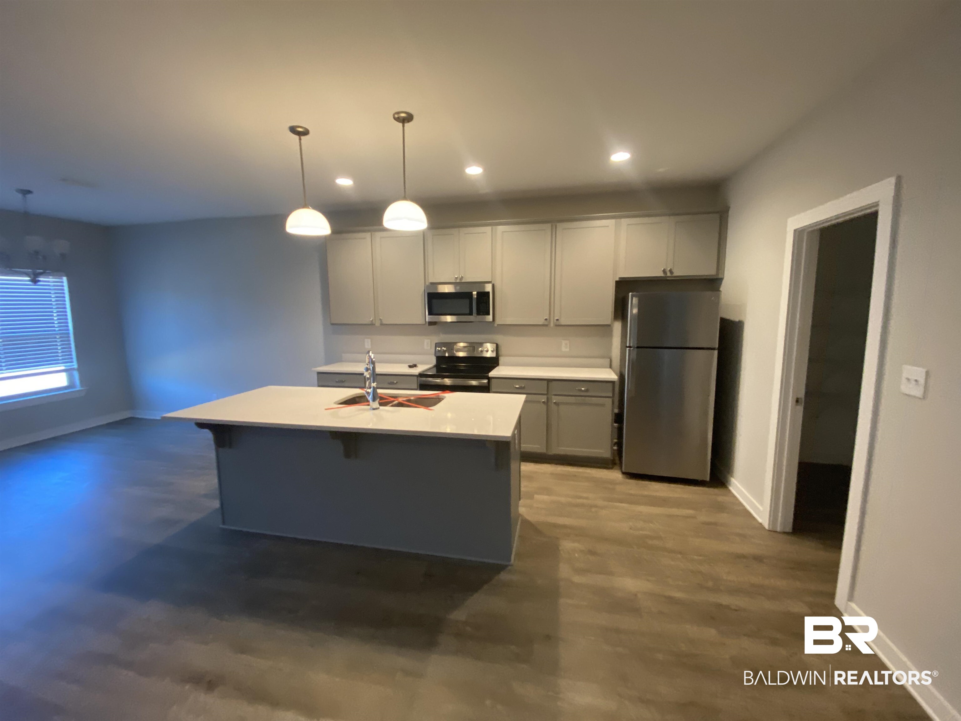 1279 Cater Lee Way Foley, AL 36535 - Photo 8 of 12 Kitchen featuring decorative light fixtures, stainless steel appliances, gray cabinets, and sink