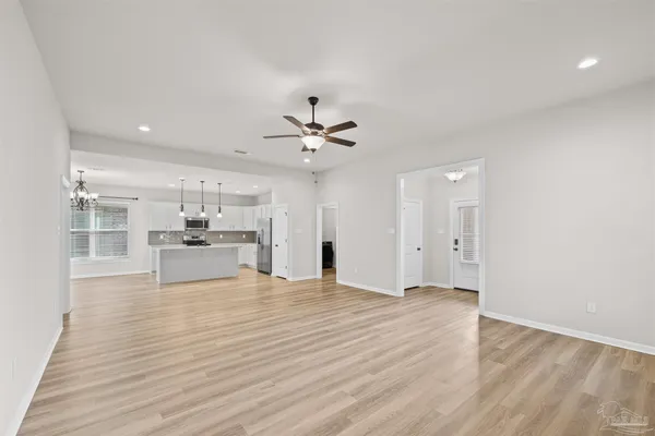 a view of kitchen with kitchen island sink and refrigerator
