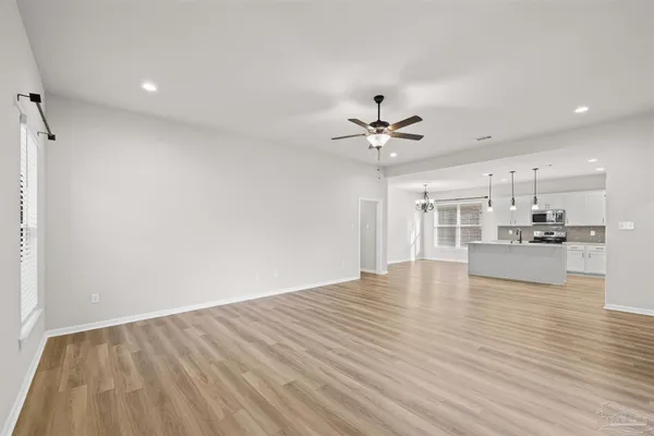 a large kitchen with kitchen island a sink stainless steel appliances and cabinets