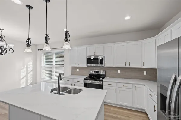 a kitchen with a refrigerator and a sink