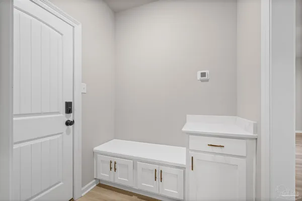 a view of empty room with wooden floor